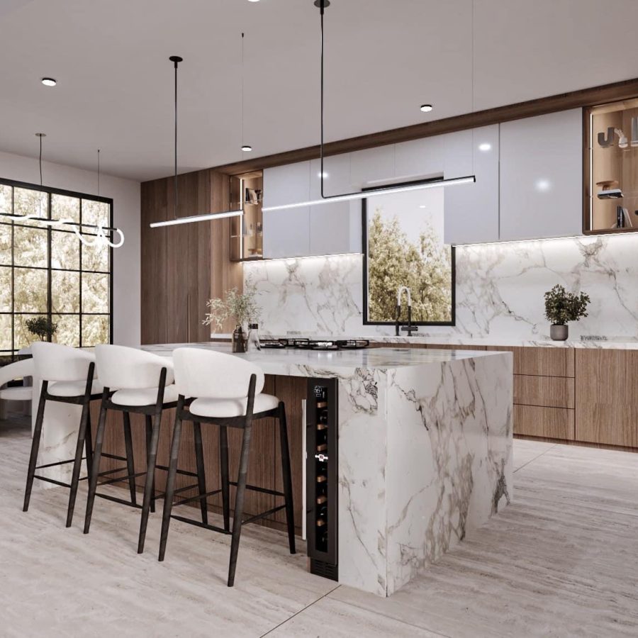 473627382_122166316040278422_2369744434174053884_n a kitchen with a marble island and chairs
