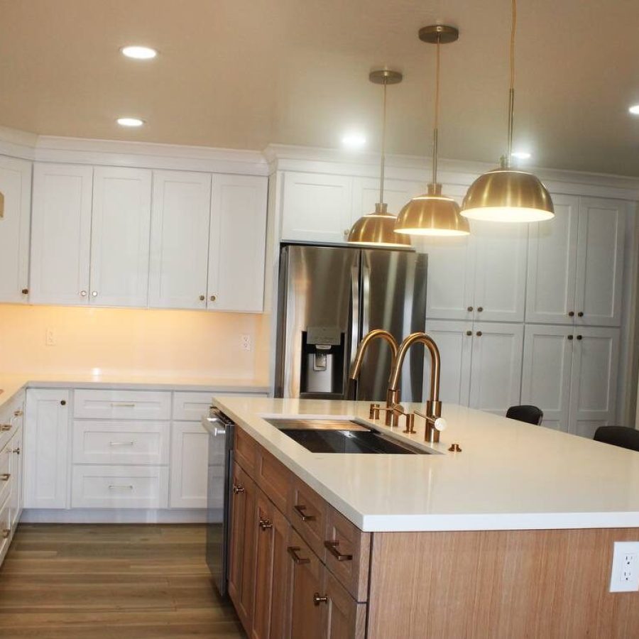 Kitchen Remodel – Mia N 1 Expert kitchen remodel. Beautiful white cabinets and countertop with a brown wood island and pendant lights hanging over it