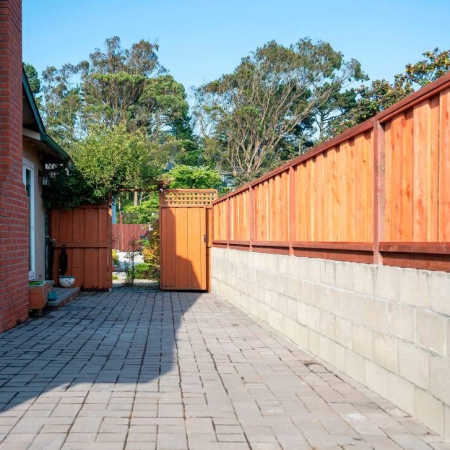 Retaining Wall – Rui Lee 31 Fence lining a gray stone patio