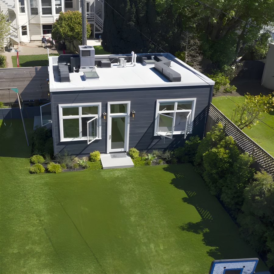 a house with a basketball hoop in the back yard