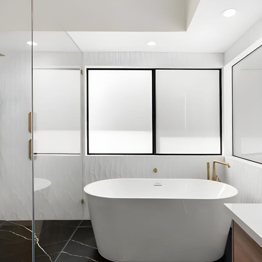 a white tub in a bathroom with black marble floors. Geico Builders, the best bathroom remodeling in Oakland