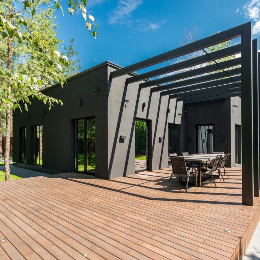 deck a house with a table and chairs on a deck. Geico Builders, the #1 ADU builder in Hayward